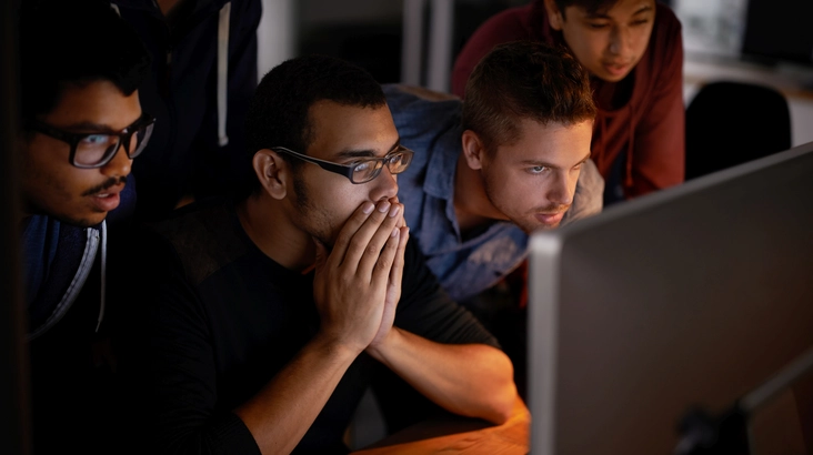 Group of people looking into a display