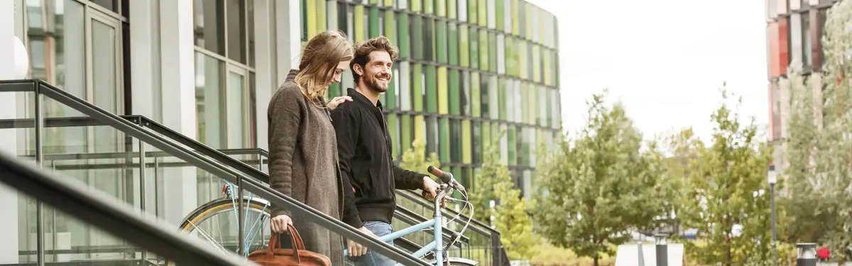 2 young people walking with a bicycle