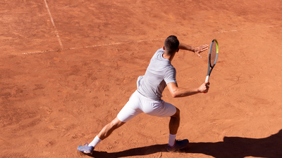A tennis player about to take a swing