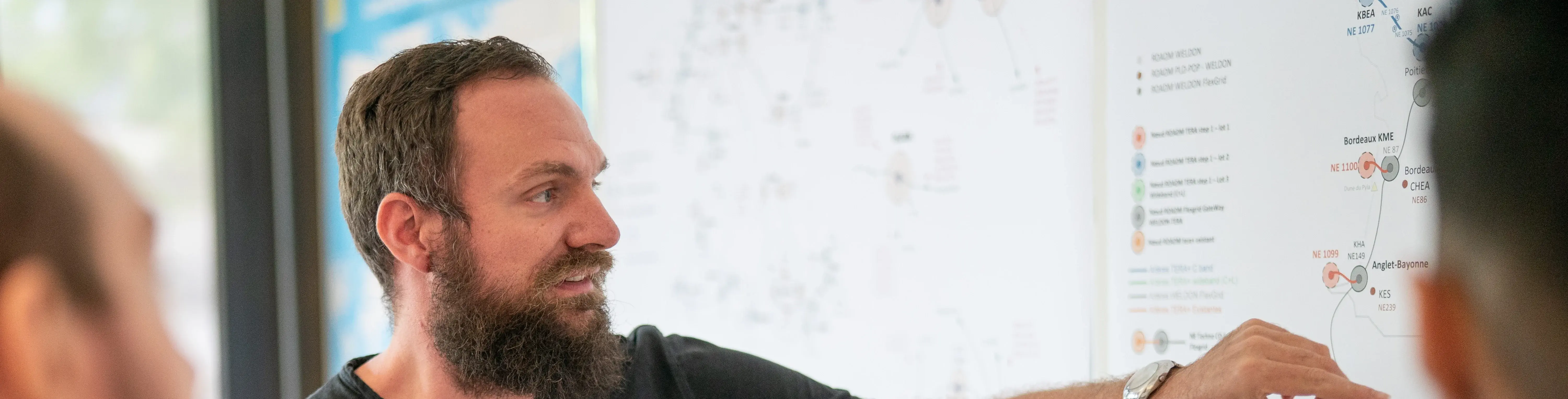 Man at Orange Cyberdefense looking at Threat Detection Map