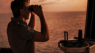 man looking with a binoculars
