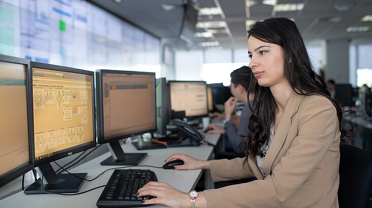 woman working with multiple screens