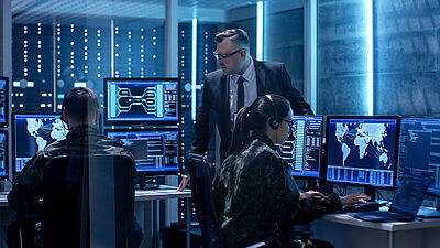 Cybersecurity situation room with experts at workstations