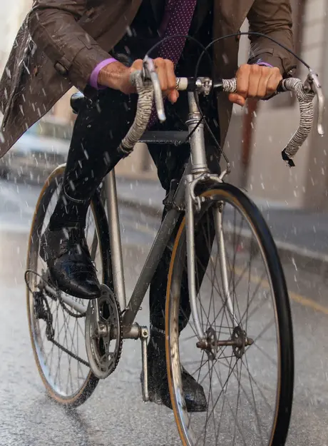Person riding a bicycle in the rain