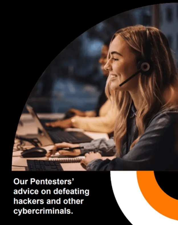 A woman wearing a headset, smiling while working at a computer, highlighting a cybersecurity or customer support environment.