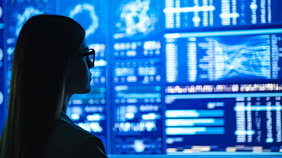 Woman looking at a wall of data