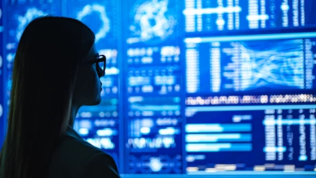 Woman looking at a wall of data