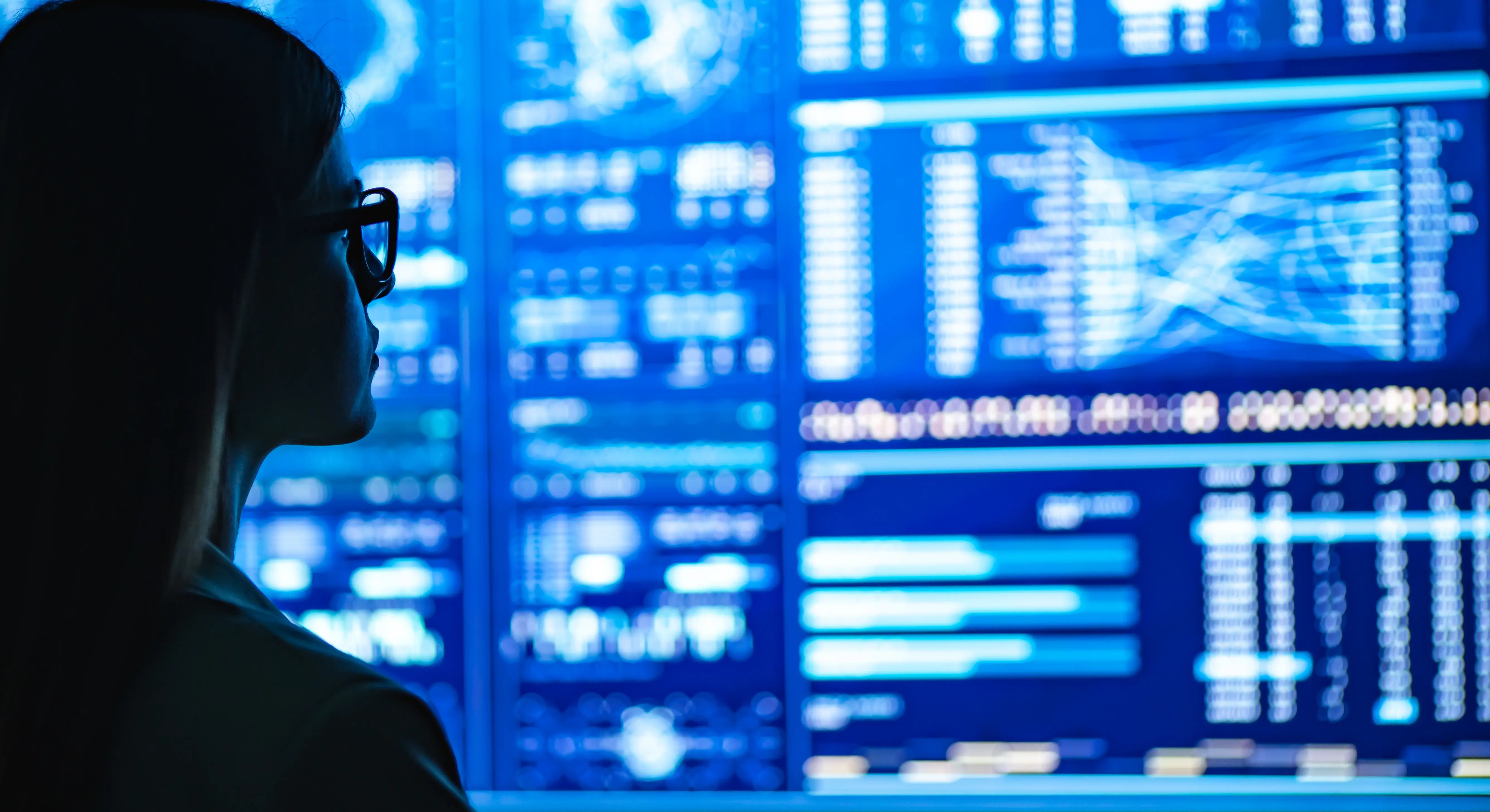 Woman looking at a wall of data