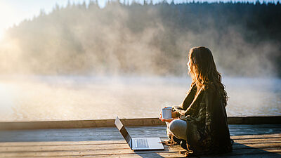Woman sitting with laptop water