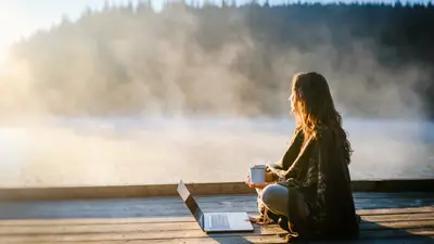 Woman sitting with laptop water