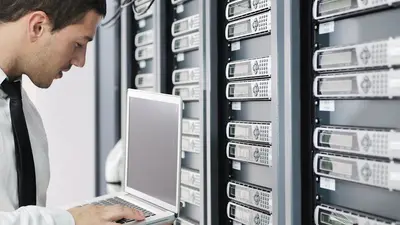 Un homme configure des disques durs dans un datacenter