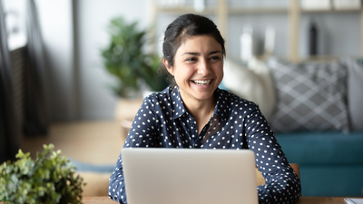Woman laptop smiles.