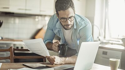 Man in kitchen laptop