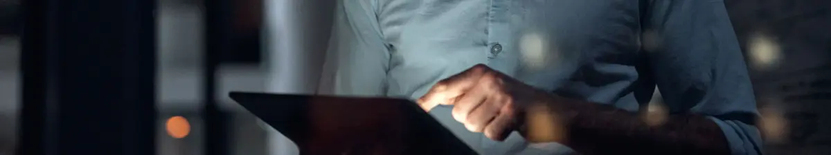 A man working on a tablet at night