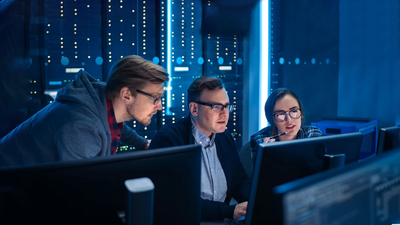 3 men looking at a screen