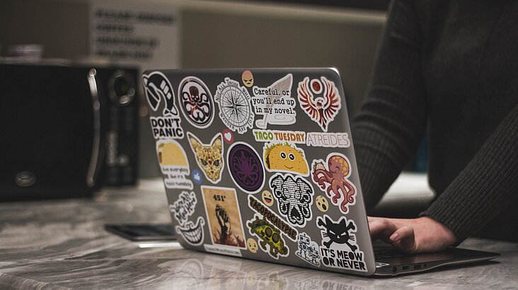 Laptop with lot of stickers on