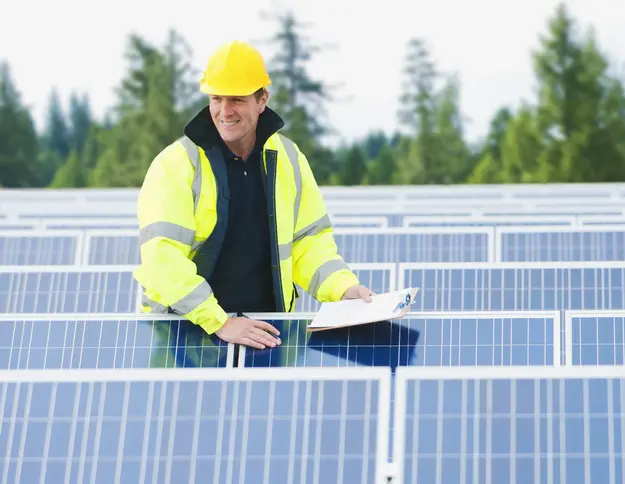 Worker inspecting a solar panel system