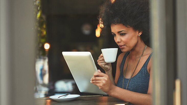 woman having coffee and working