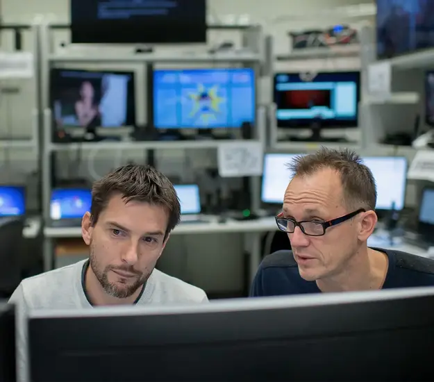 Two experts in cybersecurity working together