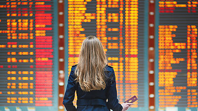 A woman standing in front of a large display screen