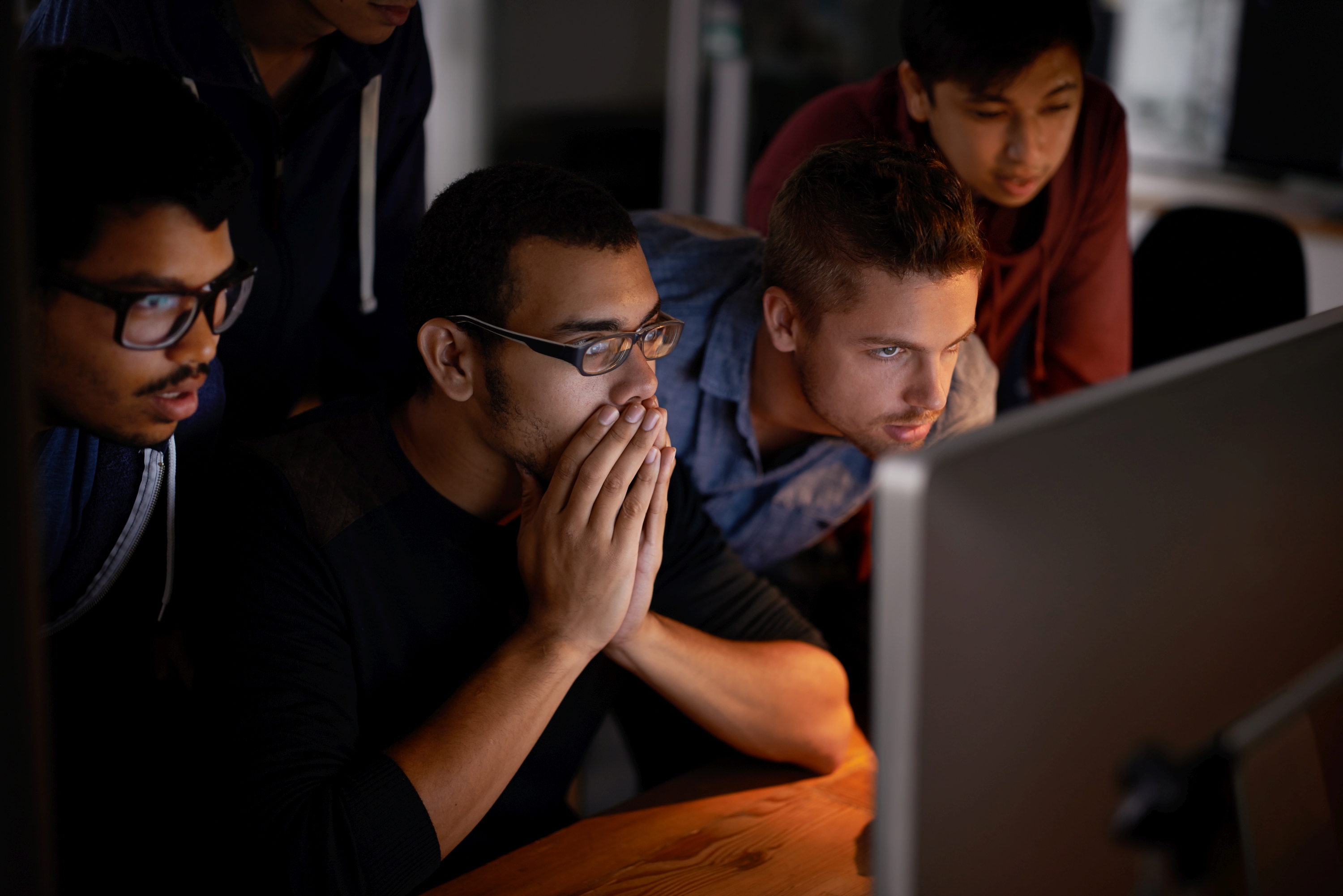 Group of people looking into a display