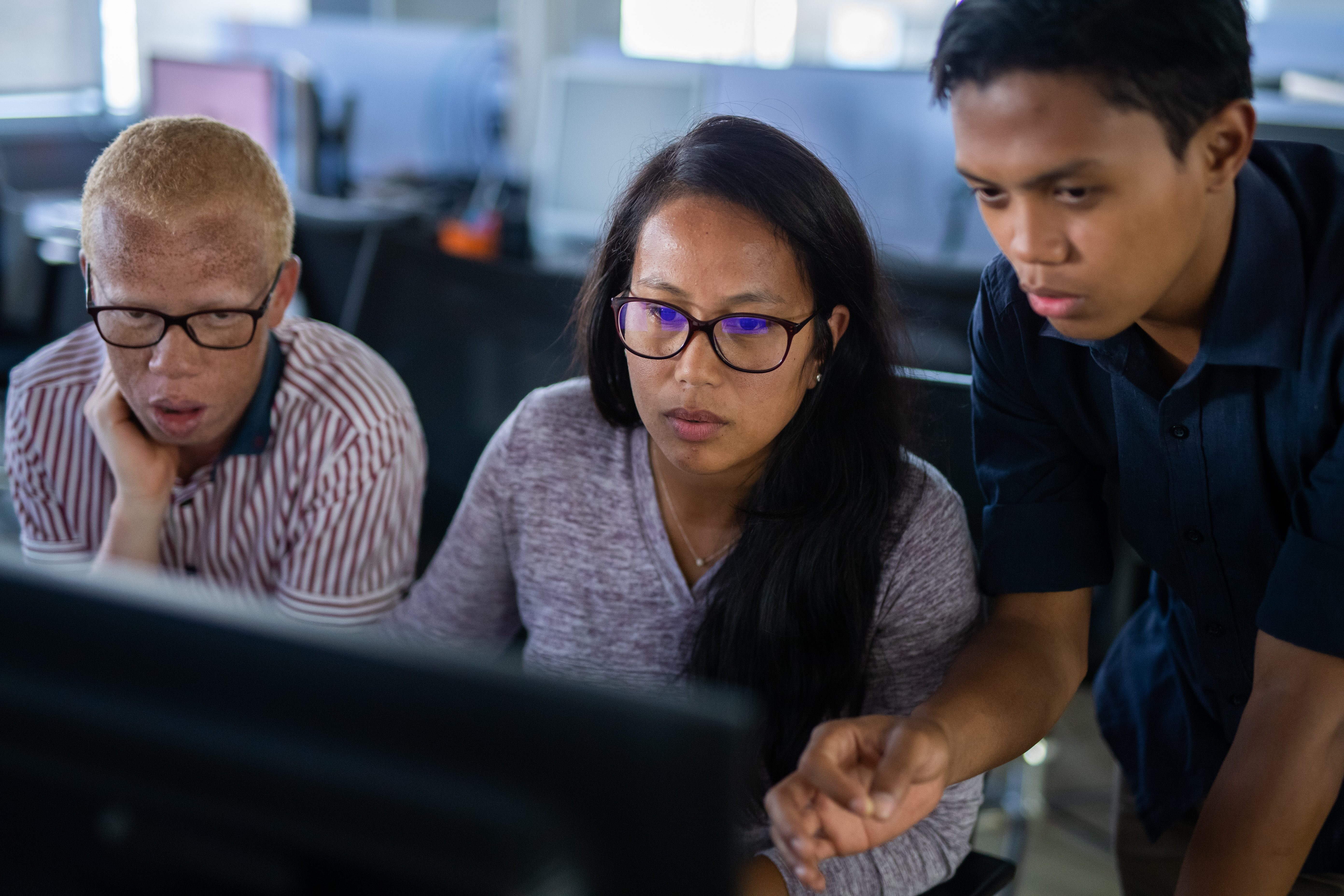 three people managing cloud security